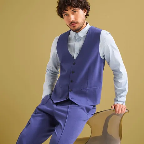 Elegant blauw pak met vest en lichtblauw overhemd.