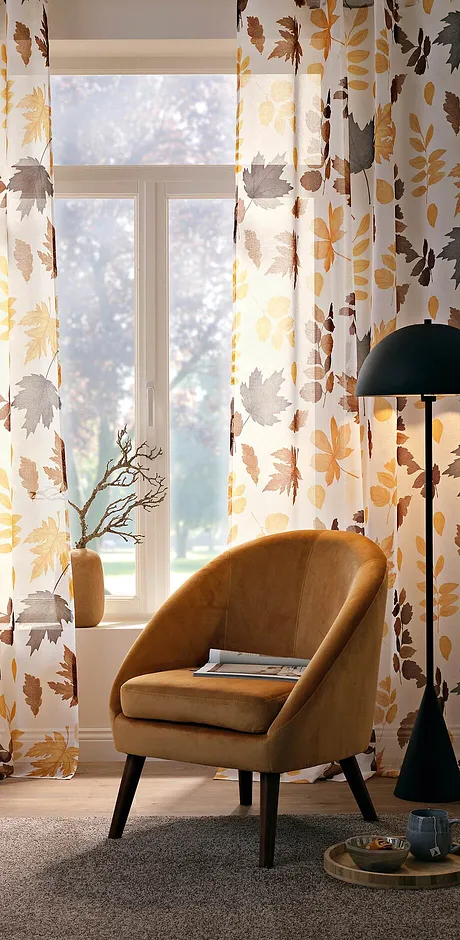 Gordijnen in herfstkleuren met een stoel in mosterdgeel zorgen voor een perfecte sfeer in je kamer.