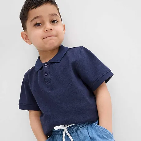 Een donkerblauw poloshirt gecombineerd met lichtblauwe jeans.