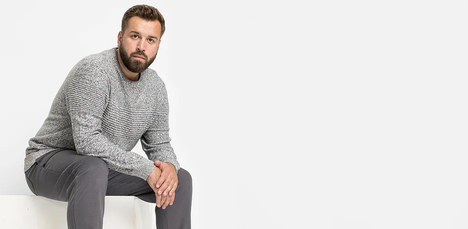 De grijze trui en grijze broek vormen samen een casual outfit.